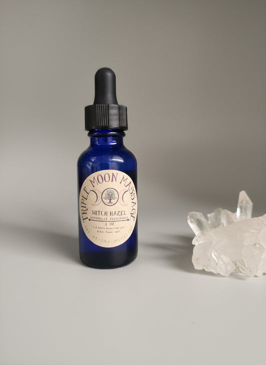 Blue dropper bottle with a label on a green surface