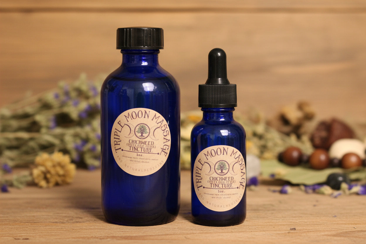 Two blue glass bottles with dropper caps on a green background